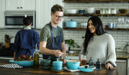 The image of a man and a woman cooking together